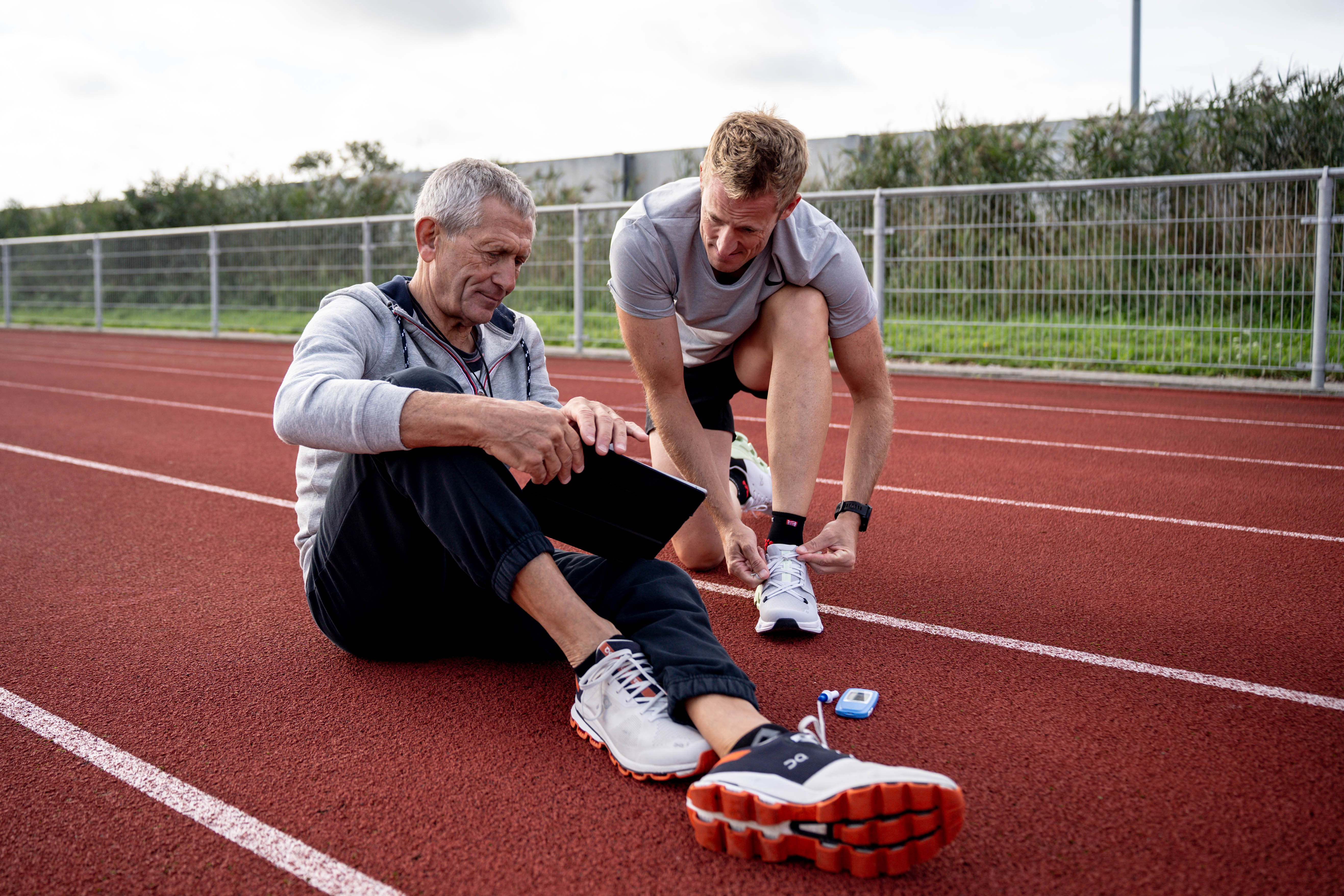Coach and athlete on running track